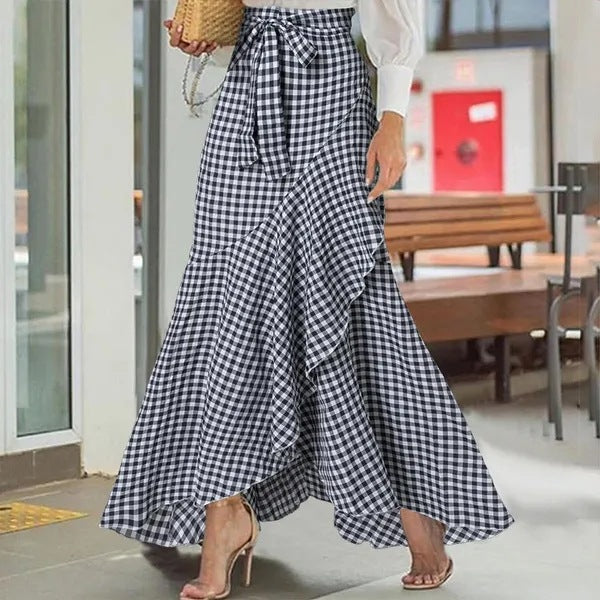 Plaid mermaid irregular skirt from M Chic Boutique with a flowing design and unique hemline, showcasing vibrant colors.