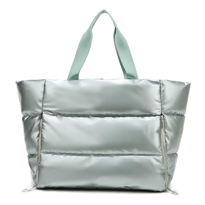 Women's gym bag by M Chic Boutique featuring a stylish, spacious bag with handles and compartments for workout essentials.