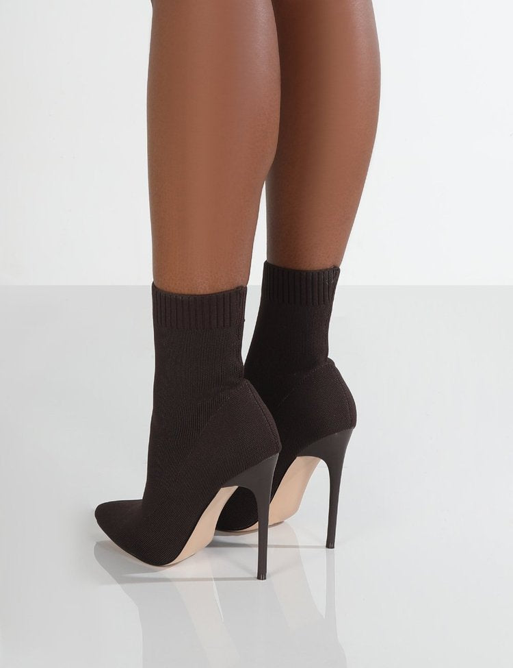 High-heel point-toe knitted boots by M Chic Boutique in a stylish design, showcasing the texture and silhouette.