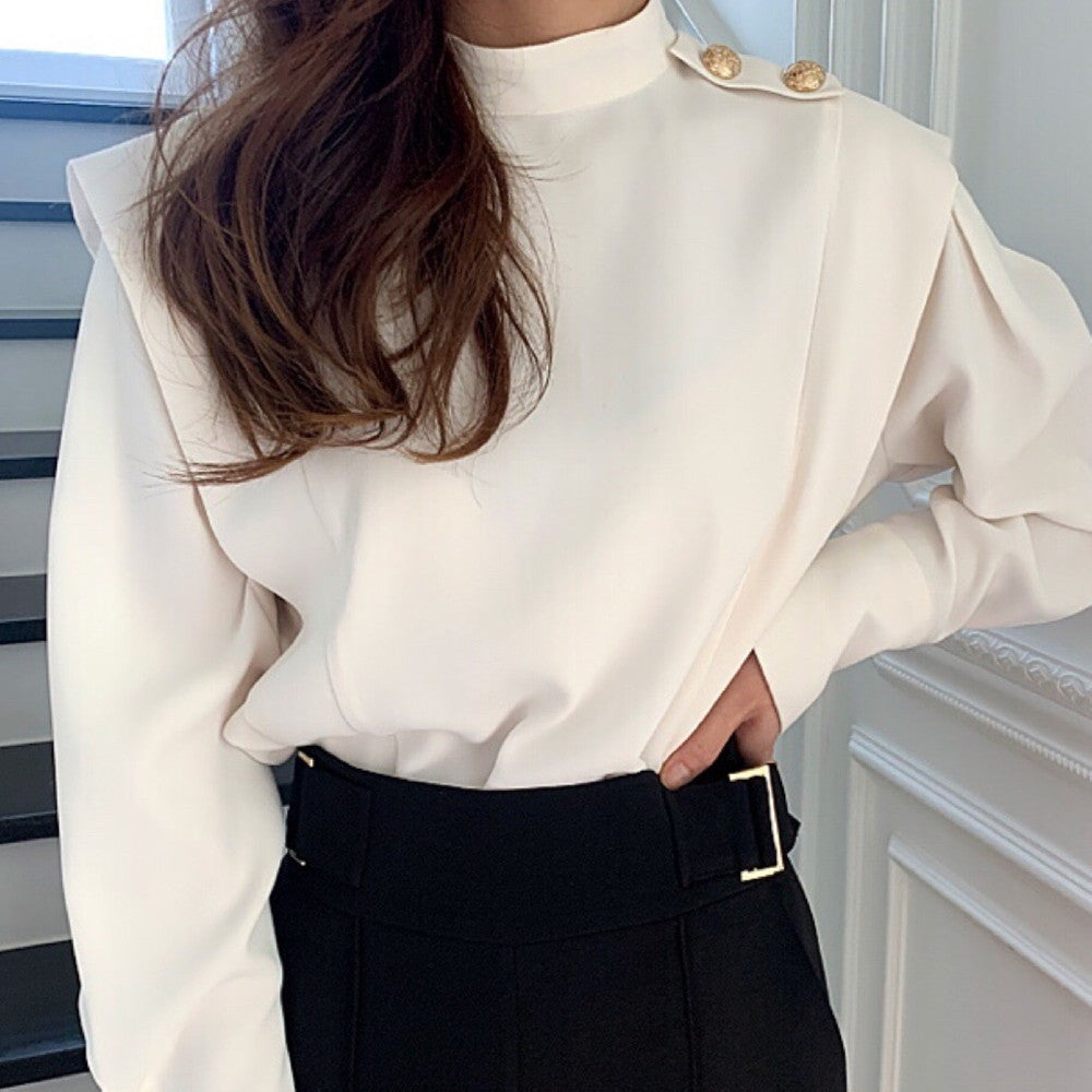 Half high collar shirt in white fabric, styled with a flowy skirt, showcasing a chic look from M Chic Boutique.