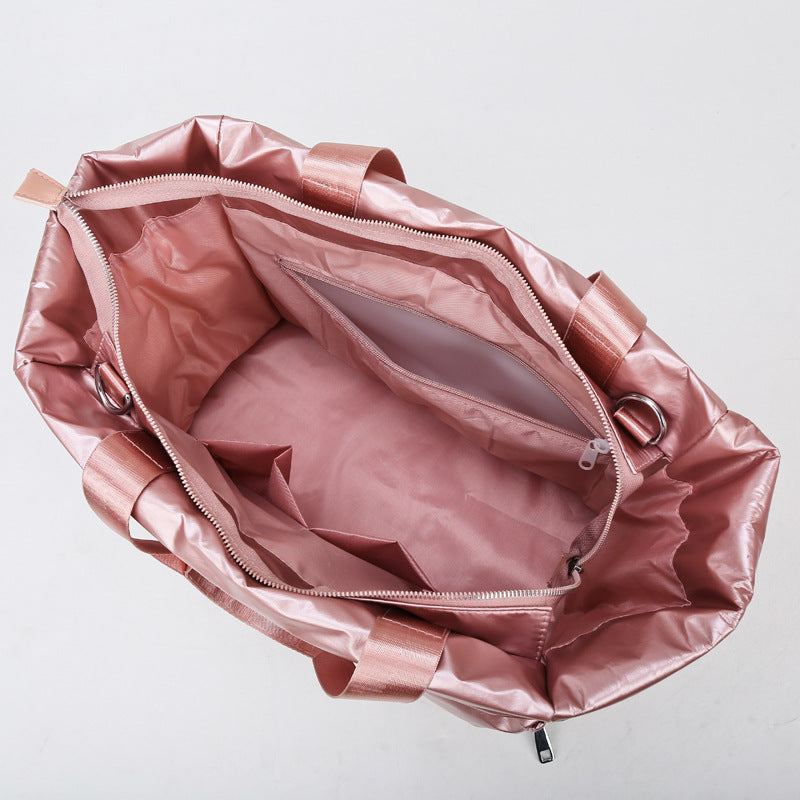 Women's gym bag by M Chic Boutique, stylish and spacious bag for workout essentials, with handles and zip closure.