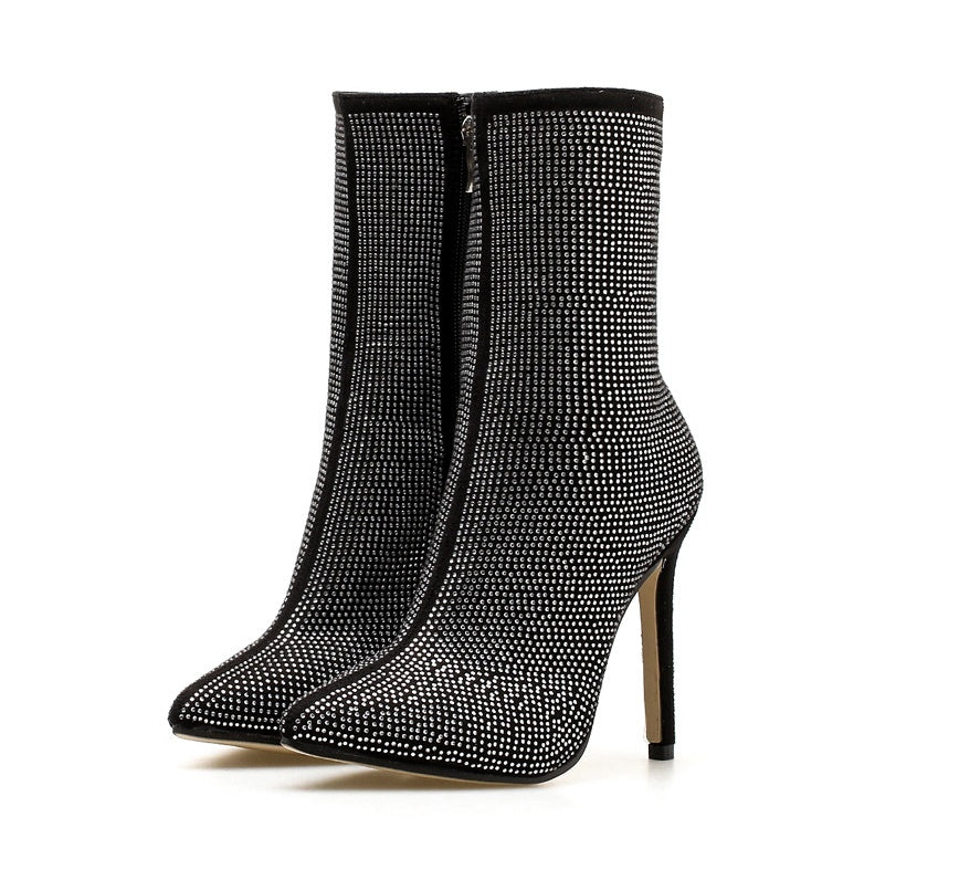 Pointed rhinestone high heel boots from M Chic Boutique featuring a sleek design and sparkling embellishments.