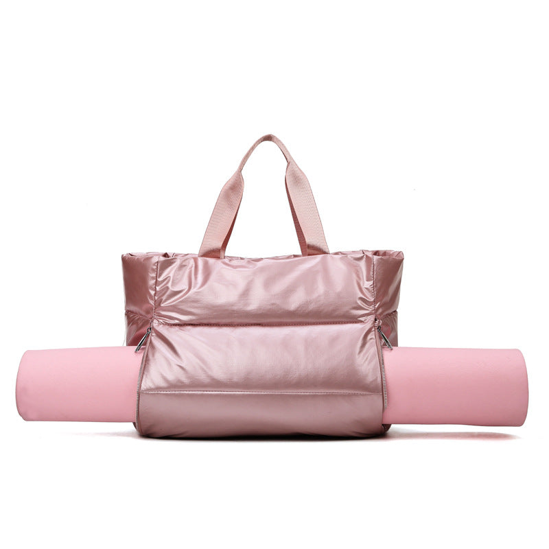 Women's gym bag by M Chic Boutique, stylish bag with compartments for workout gear and essentials, black fabric with handles.