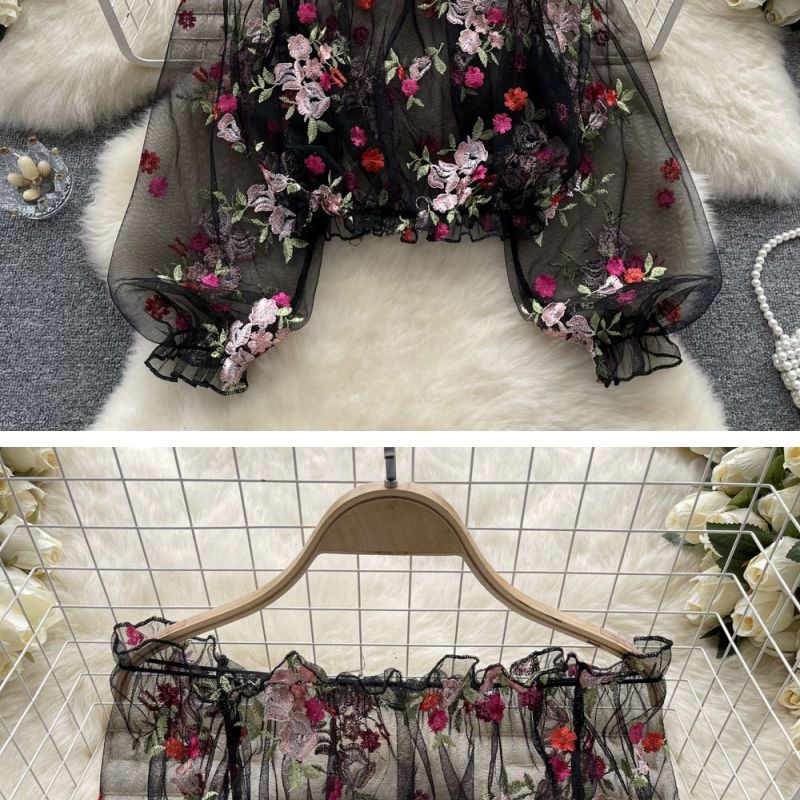 Elegant off-shoulder mesh embroidery transparent shirt from M Chic Boutique, showcasing intricate embroidery and sheer fabric.