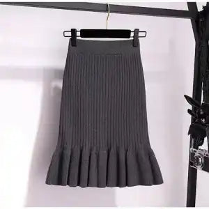 Ruffled high waisted skirt in a flowy design, showcasing soft fabric and layered details from M Chic Boutique.