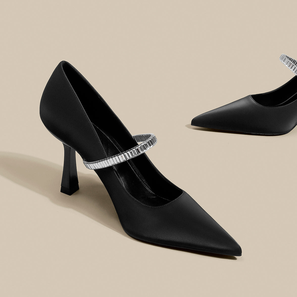 Black pointed toe shoes with strap from M Chic Boutique, featuring a sleek design and elegant silhouette.