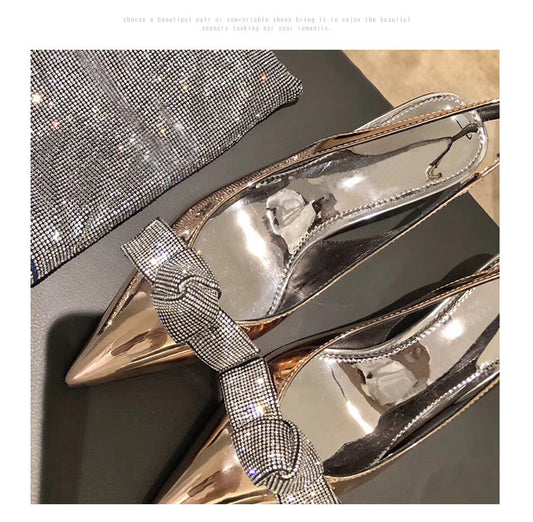 High heels with pointed silver bow