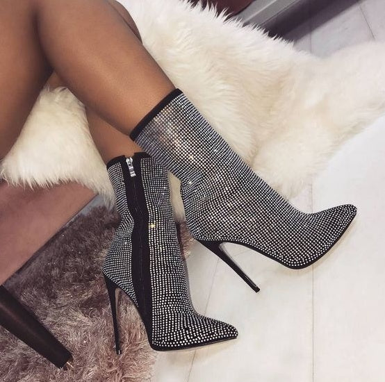 Pointed rhinestone high heel boots from M Chic Boutique with a stylish design and shimmering embellishments.