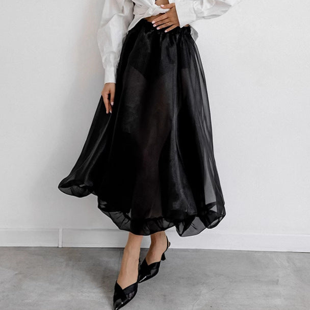 Black mesh high waist skirt from M Chic Boutique, featuring a flowing design and elegant silhouette.