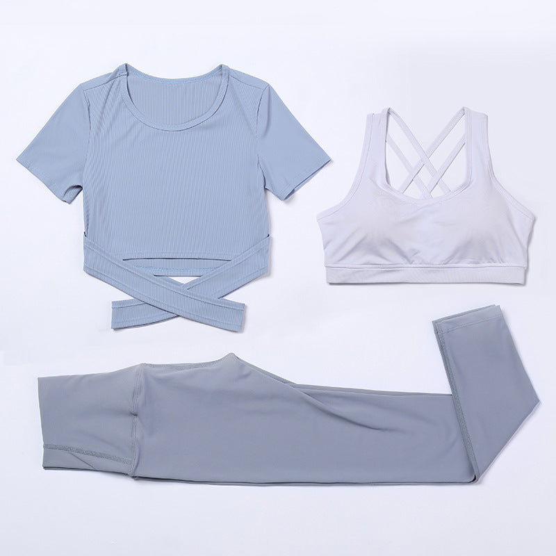 Three-piece M Chic Boutique activewear yoga and gym suit with matching top, leggings, and sports bra on a white background.