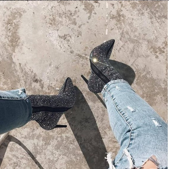 Pointed rhinestone high heel boots from M Chic Boutique with a sleek design and sparkling embellishments.