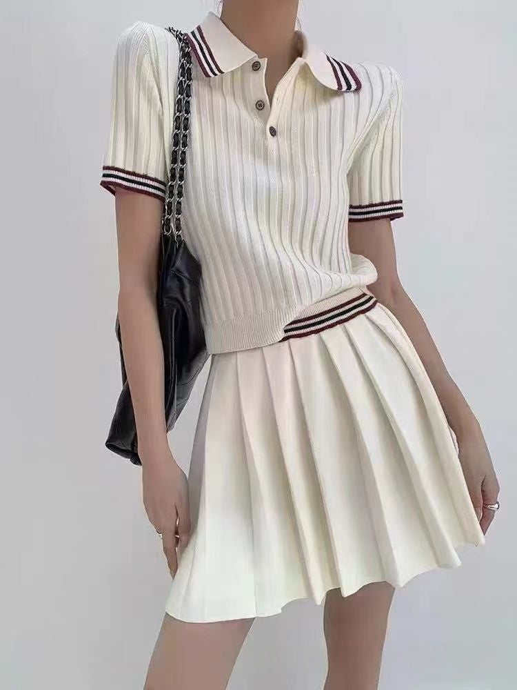 Water-themed image showing a short knitted pleated skirt two-piece set by M Chic Boutique displayed on a mannequin.