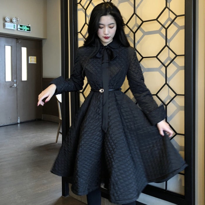 Long-sleeved cotton coat from M Chic Boutique displayed on a hanger, showcasing its stylish design and fabric texture.