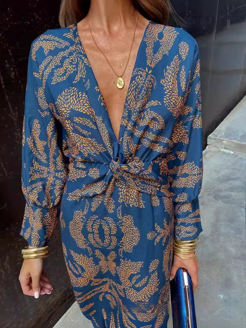 Nine-quarter sleeve V-neck painted dress by M Chic Boutique, featuring a stylish design and vibrant colors, shown on a model.