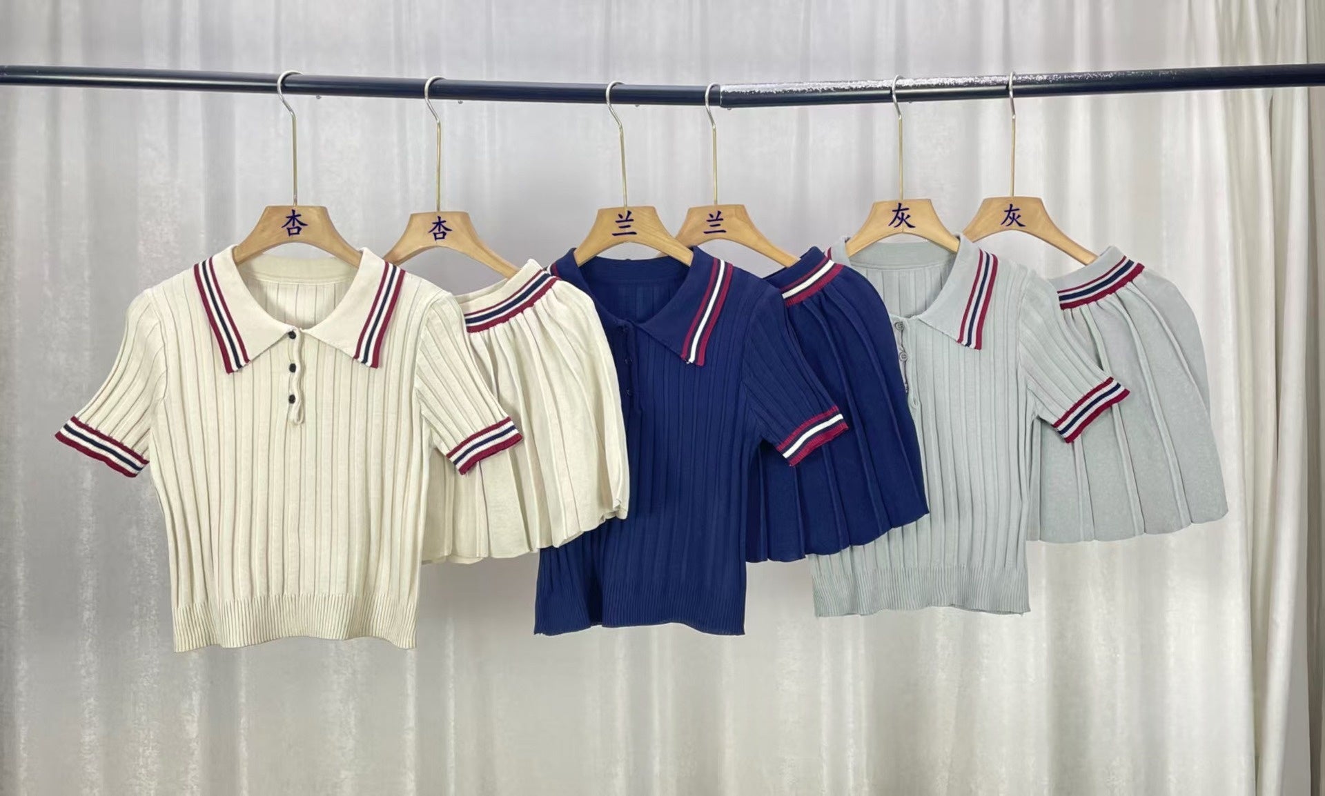 Water-colored image of M Chic Boutique's short knitted pleated skirt two-piece set, featuring a stylish knitted skirt and matching top.