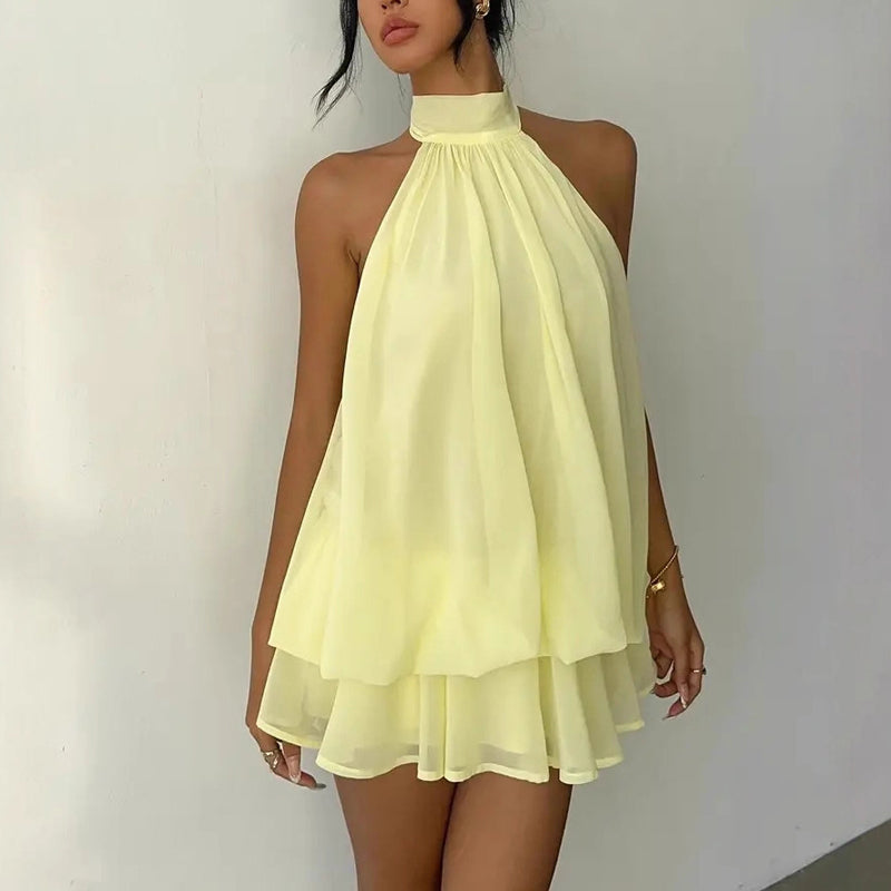 Elegant halter mini dress with bow detail, showcasing a stylish design and flattering silhouette by M Chic Boutique.