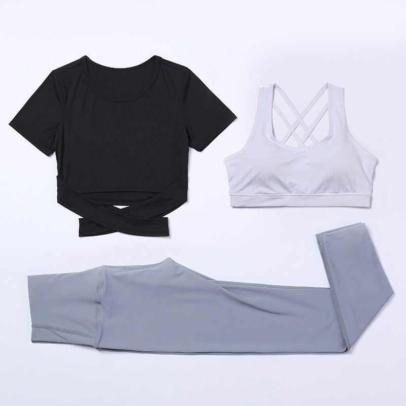 Three-piece M Chic Boutique activewear yoga and gym suit, including top, leggings, and jacket, in stylish athletic fabric.