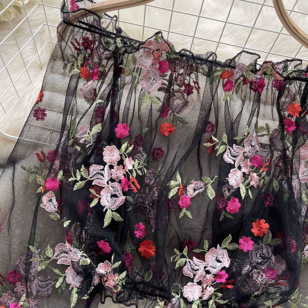 Elegant off-shoulder mesh embroidery transparent shirt from M Chic Boutique, showcasing intricate embroidery and sheer fabric details.