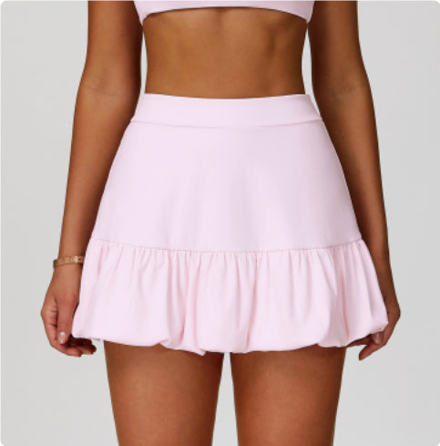 M Chic Boutique quick-drying tennis skirt shown on a model, lightweight activewear with a sporty design and comfortable fit.