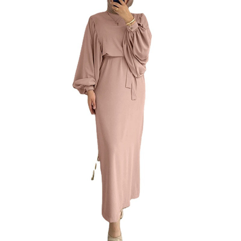 Solid color elegant dress from M Chic Boutique hanging on a mannequin, showcasing its simple yet sophisticated design.