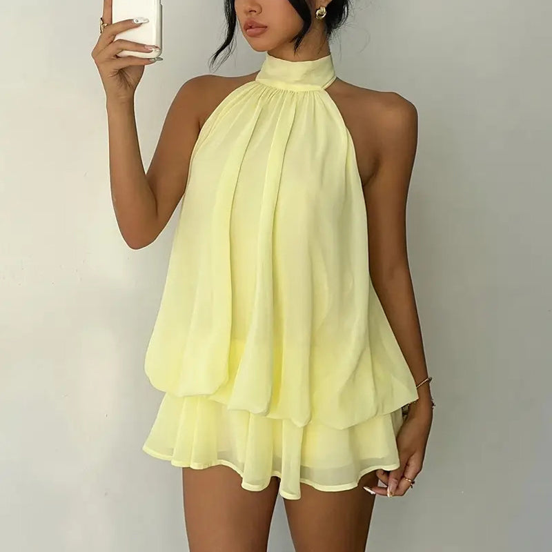 Elegant halter mini dress with bow detail, featuring a fitted bodice and flared skirt in a stylish design by M Chic Boutique.