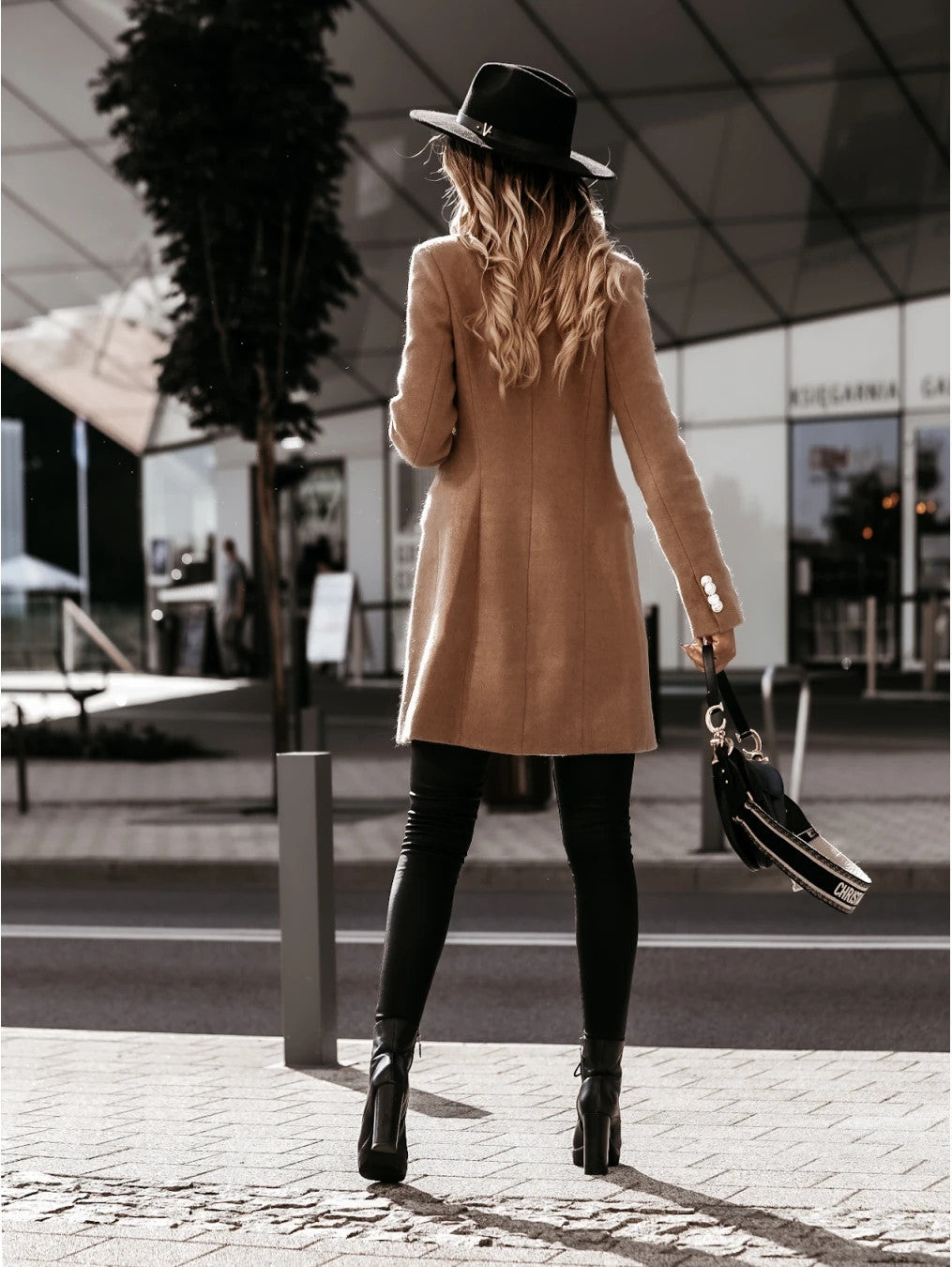 Double-breasted woolen coat from M Chic Boutique in a stylish design, featuring a warm fabric and elegant silhouette.
