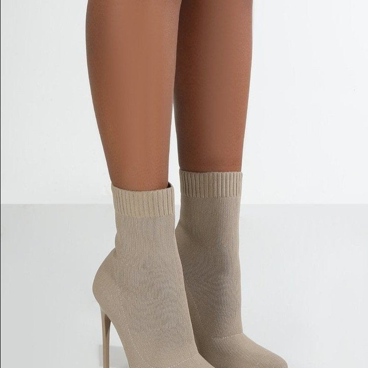 High-heel point-toe knitted boots in black with a sleek design from M Chic Boutique on a white background.