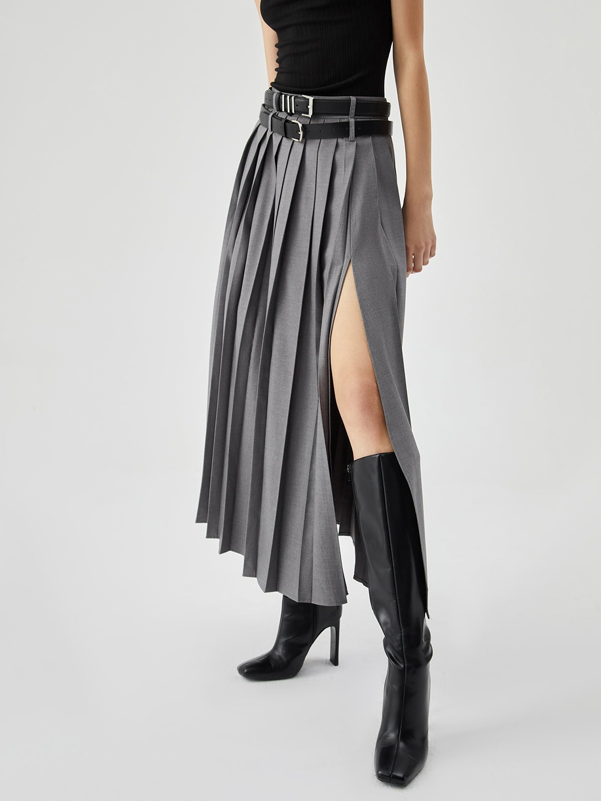 High waist slit pleated skirt in a flowing design, showcasing elegant pleats and a stylish slit from M Chic Boutique.