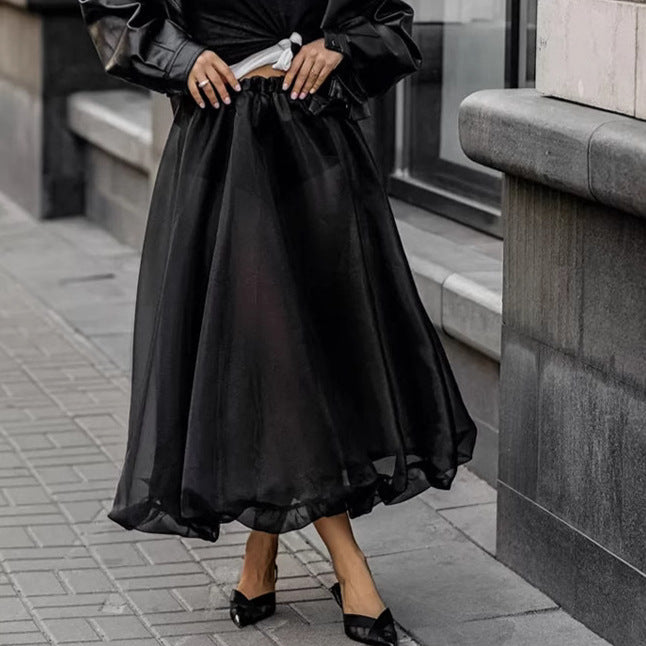 Black mesh high waist skirt from M Chic Boutique, featuring a flowy design and layered look for a stylish silhouette.