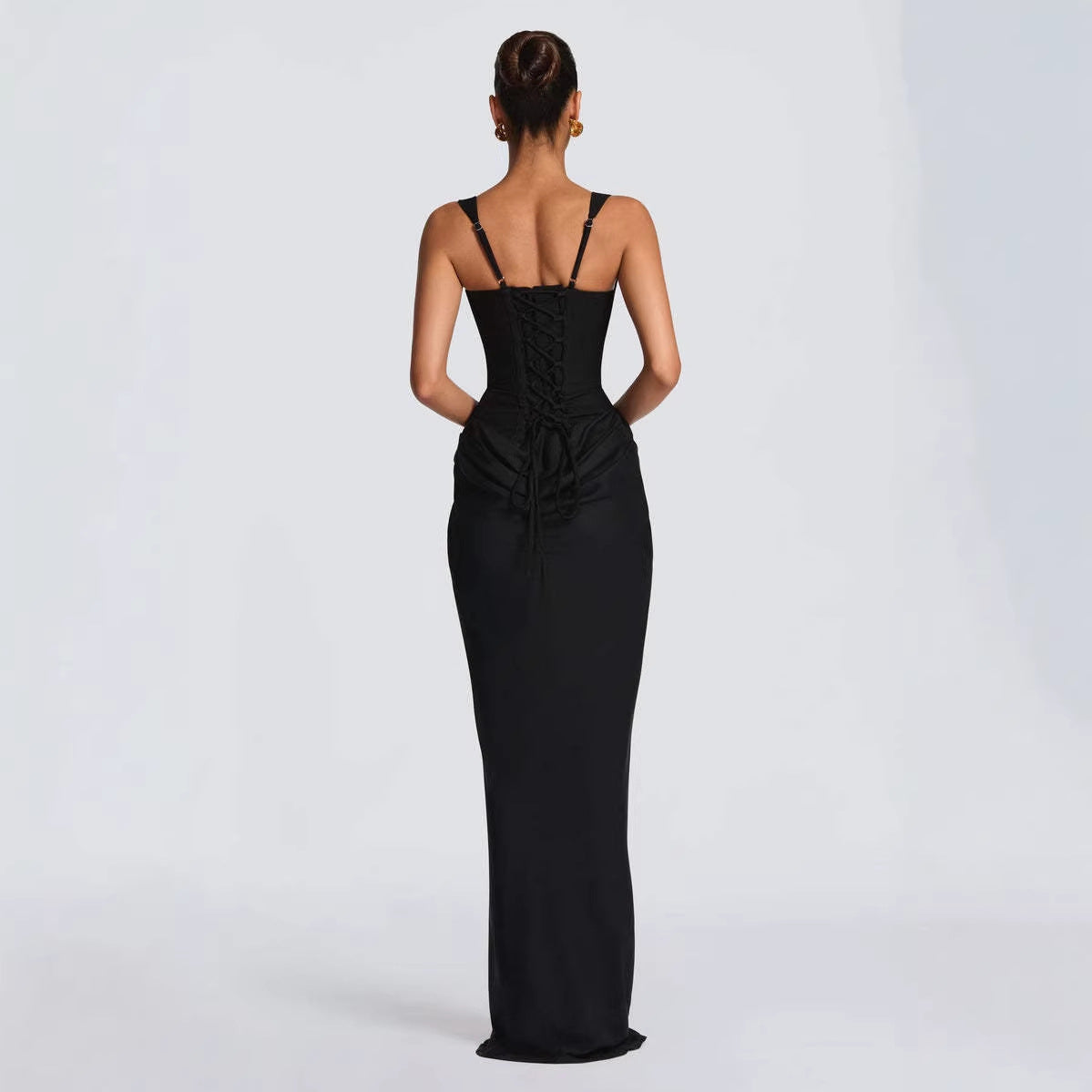 Elegant strapless sleeveless sheath maxi dress by M Chic Boutique, featuring a fitted silhouette and flowing fabric.
