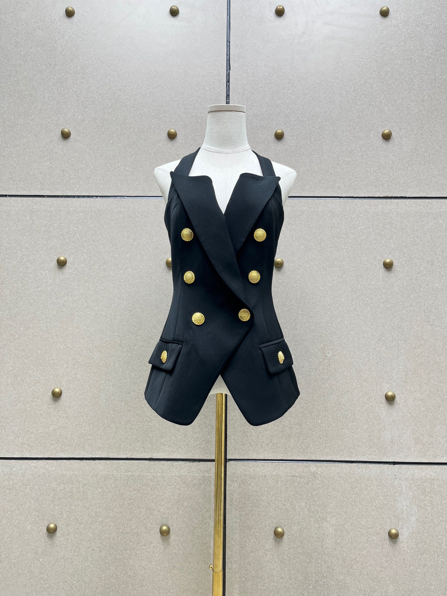 Double breasted sling vest in a tailored suit style by M Chic Boutique, featuring a sleek design and modern cut.