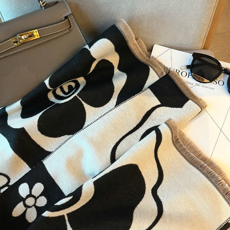 Black and white versatile scarf from M Chic Boutique, styled as a fashion accessory with a soft, flowing fabric design.
