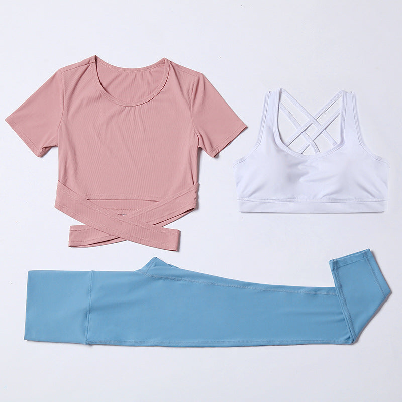 Three-piece M Chic Boutique activewear gym and yoga suit with matching top, leggings, and sports bra on a white background.