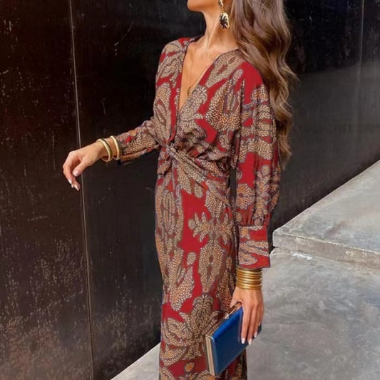 Nine-quarter sleeve V-neck painted dress by M Chic Boutique, showcasing a stylish, colorful dress with a fitted silhouette.