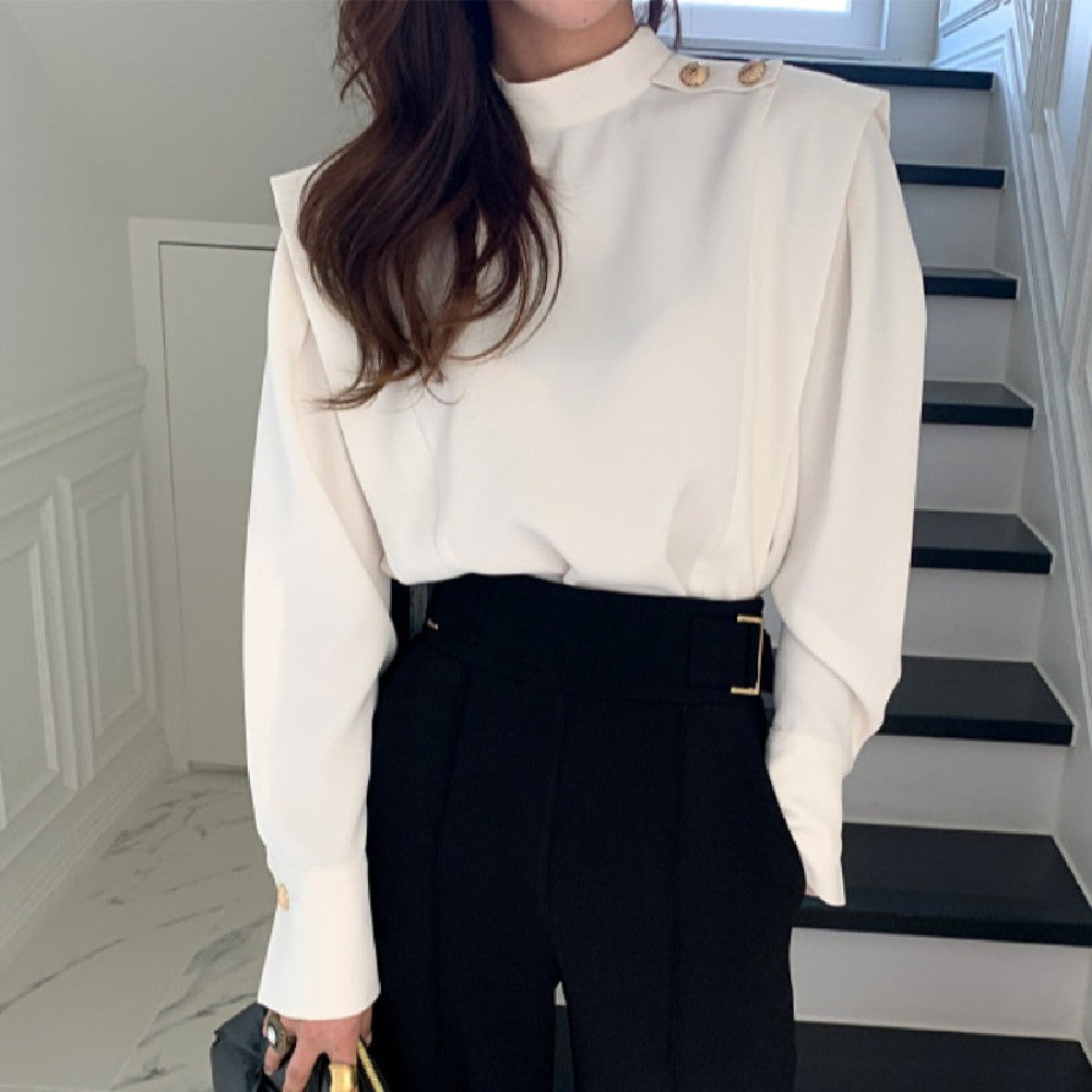 Half high collar shirt in white fabric, styled with a flowy skirt from M Chic Boutique, showcasing elegant draping and details.