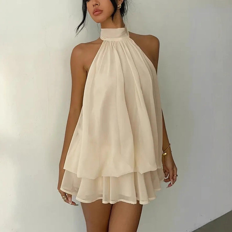 Elegant halter mini dress with a bow detail, featuring a fitted silhouette and delicate fabric from M Chic Boutique.