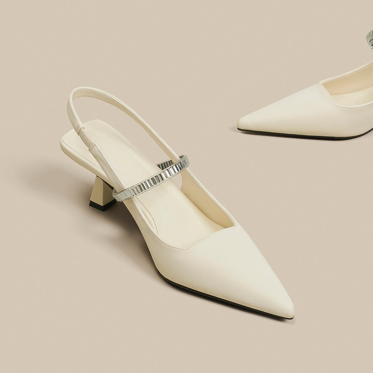 Pointed toe shoes with strap in black from M Chic Boutique, showcasing a sleek design and elegant silhouette.