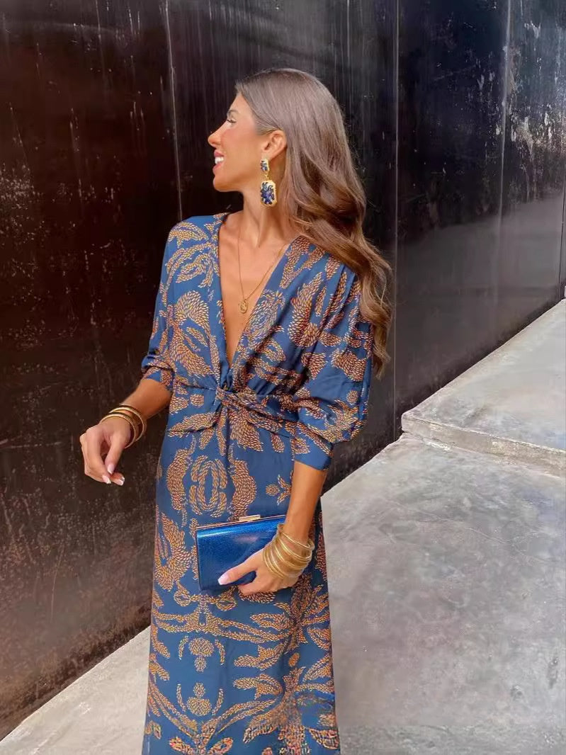 Nine-quarter sleeve V-neck painted dress by M Chic Boutique, featuring a stylish design and comfortable fit.