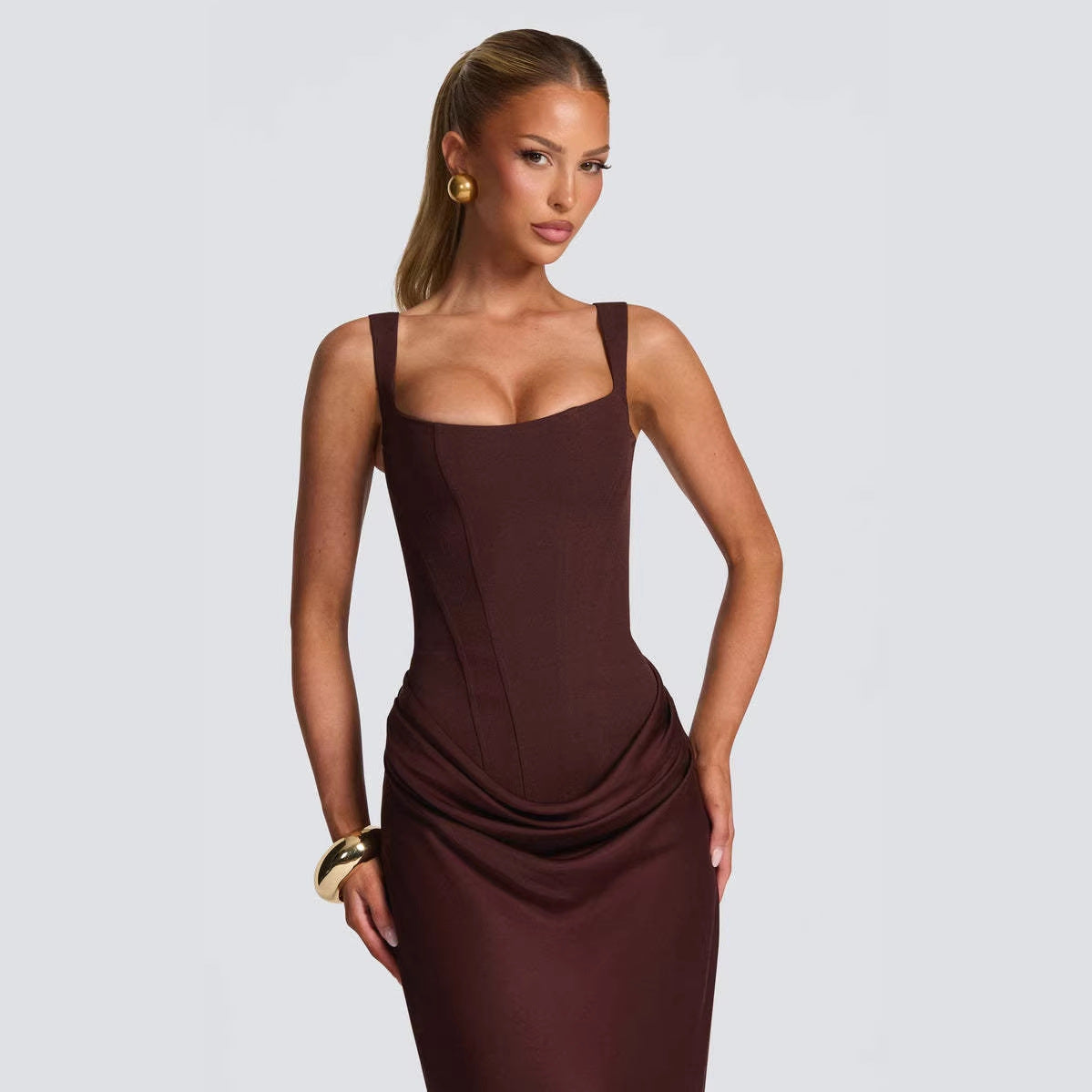 Strapless sleeveless sheath maxi dress by M Chic Boutique featuring a fitted silhouette and flowing fabric.