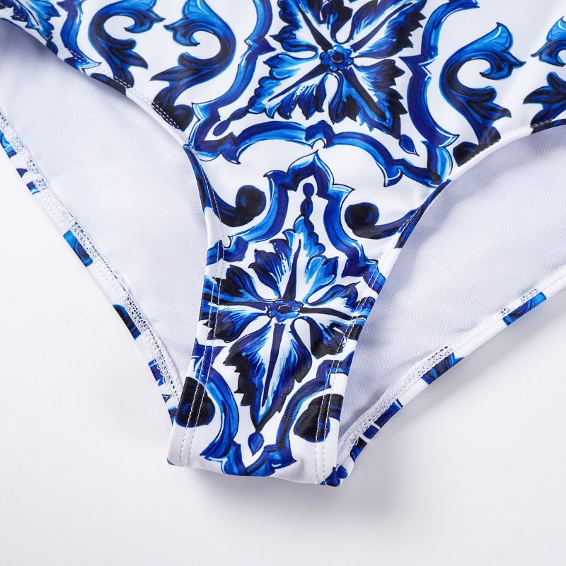 One-piece blue and white porcelain printed swimsuit for women by M Chic Boutique, showcasing intricate floral patterns.
