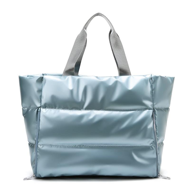 Women's gym bag by M Chic Boutique, stylish and spacious bag with handles and zip closure for fitness and athletic use.