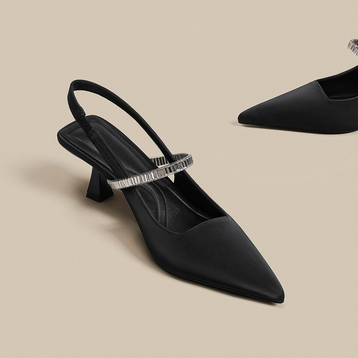 Pointed toe shoes with strap in black from M Chic Boutique, featuring a sleek design and elegant silhouette.