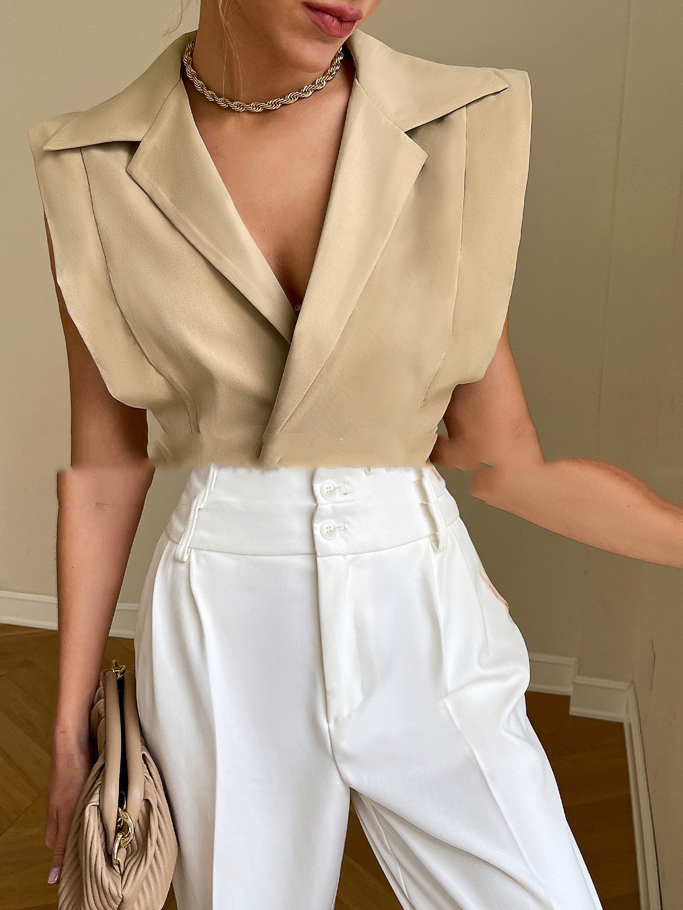 Solid color suit top from M Chic Boutique displayed on a hanger, featuring a sleek design and elegant fabric.