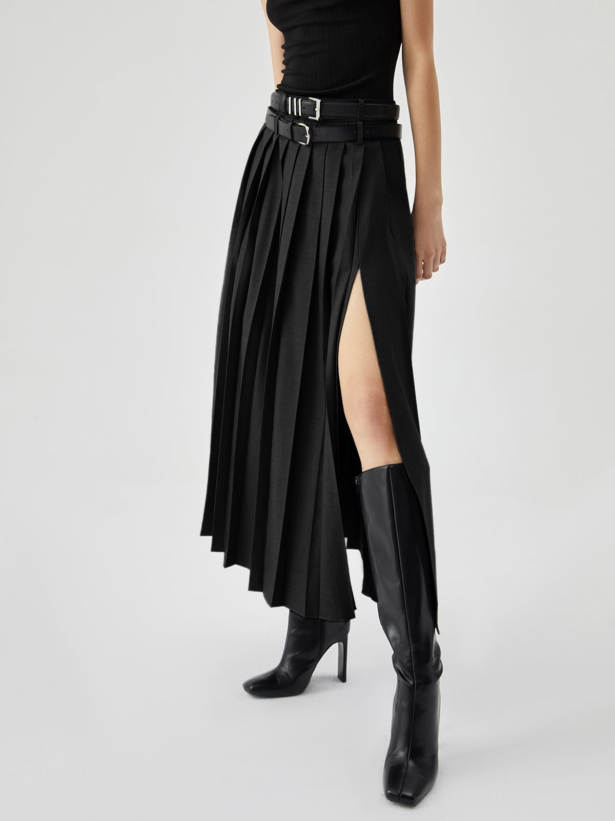 High waist pleated skirt with side slit, featuring a flowy design in a stylish look by M Chic Boutique.