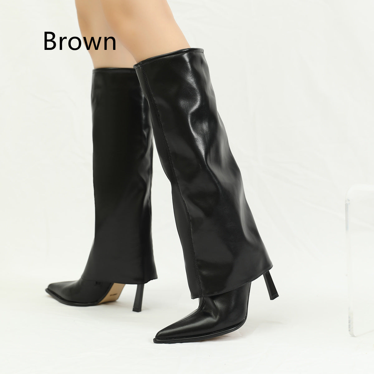 Long British style stiletto heel boots by M Chic Boutique, featuring sleek design and elegant silhouette.