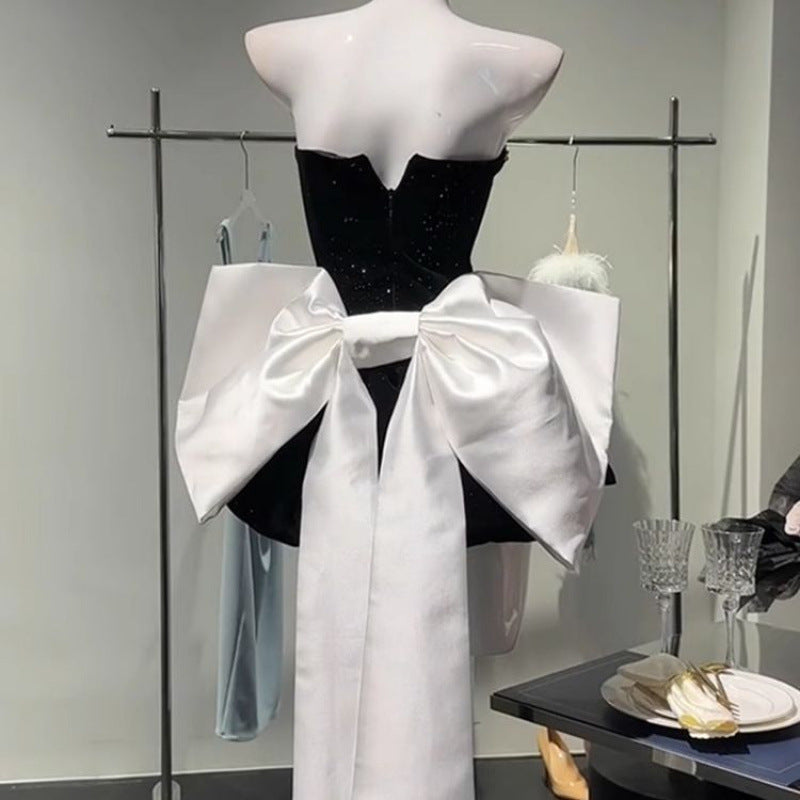 Elegant high-end light luxury dress with a bow detail, designed by M Chic Boutique.