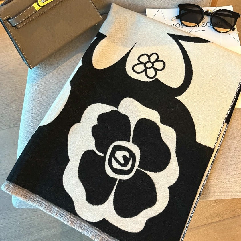 Black and white scarf from M Chic Boutique, versatile accessories with stylish pattern and soft fabric for fashionable wear.