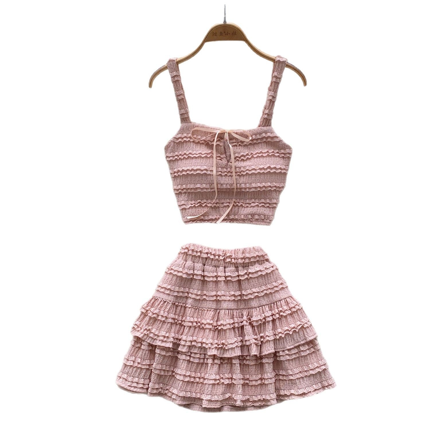 Two-piece M Chic Boutique square-neck slip dress set with high waist and pleated ruffled hem, displayed on a hanger.