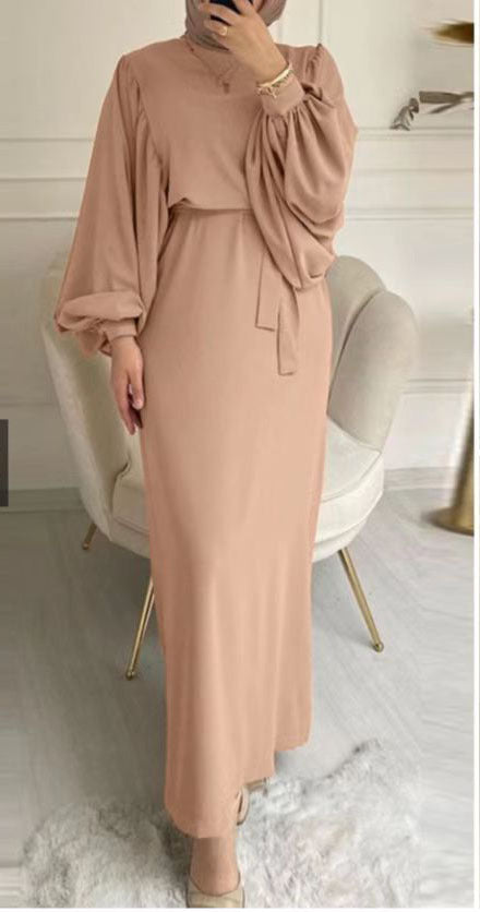 Solid color elegant dress from M Chic Boutique, featuring a sleek design and flattering silhouette on a model.