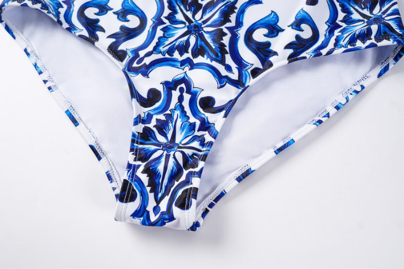 One-piece blue and white porcelain printed swimsuit for women by M Chic Boutique, showcasing elegant floral patterns.